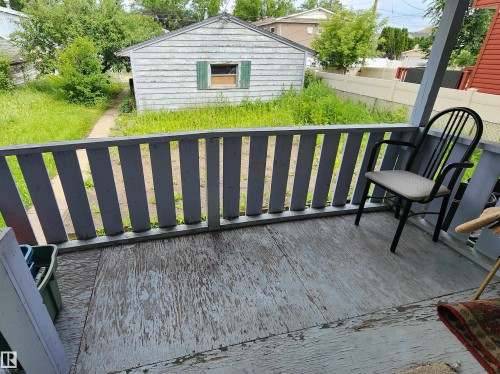 Rear porch with slatted railing, providing access to the backyard - 9522 110 Avenue Nw, Edmonton, AB - Outdoor With Exterior