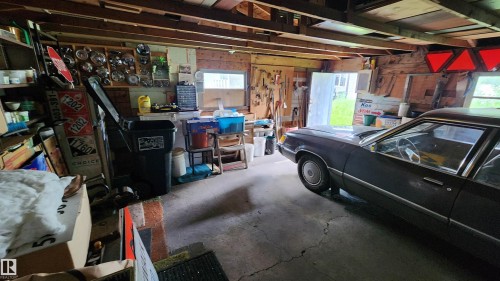 Garage space featuring exposed ceiling joists and concrete flooring - 9522 110 Avenue Nw, Edmonton, AB - Indoor Photo Showing Garage