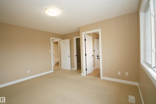 Carpeted room with neutral wall tones and white baseboards - 11513 17 Avenue, Edmonton, AB 