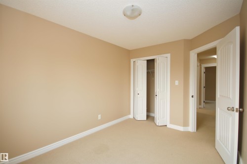 Neutral-toned wall paint and carpeting throughout - 11513 17 Avenue, Edmonton, AB 