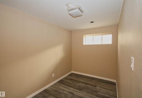 Room featuring wood-finish flooring, a window, and recessed ceiling lighting - 11513 17 Avenue, Edmonton, AB 