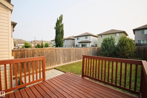 Expansive wood-finish deck with integrated railing - 11513 17 Avenue, Edmonton, AB 