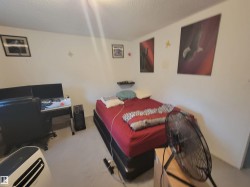 Wall-to-wall carpeting in a neutral tone complements the light-colored walls - 