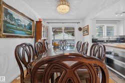 Dining area with a crystal chandelier and light-toned flooring - 
