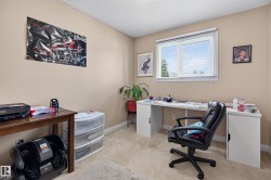 Beige painted walls, light carpet flooring, and a window with horizontal blinds - 