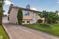 Yellow exterior with white trim, featuring a front entry with sidelights - 
