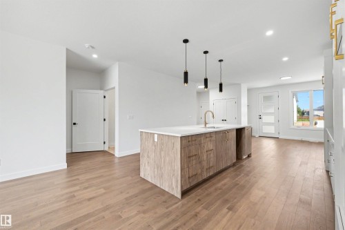 Open-concept living space with wood-finish flooring - 39 Elsinore Place, Edmonton, AB 
