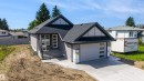 Contemporary ranch-style home featuring gray horizontal siding and a dark shingle roof - 39 Elsinore Place, Edmonton, AB 