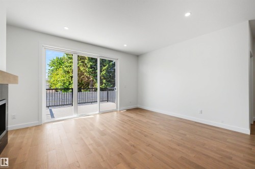 Bright interior space featuring light wood-finish flooring, recessed lighting, and white walls - 39 Elsinore Place, Edmonton, AB 