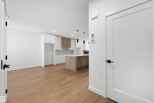 Open concept interior featuring wood-finish flooring and recessed lighting - 39 Elsinore Place, Edmonton, AB 