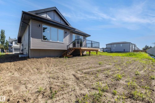 Rear exterior featuring grey horizontal siding and a dark roof - 39 Elsinore Place, Edmonton, AB 