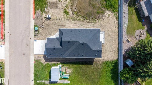 New construction residence featuring a dark shingle roof and a concrete driveway - 39 Elsinore Place, Edmonton, AB 