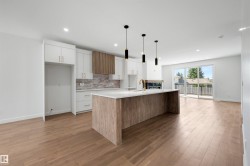 Modern kitchen featuring a central island with a wood-finish base, integrated sink, and gold-tone faucet - 