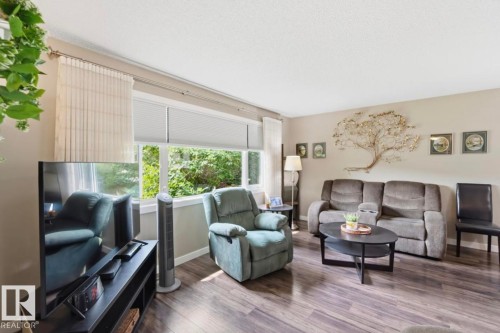 Living area featuring wood-finish flooring and neutral wall tones - 4007 45 Street, Stony Plain, AB 