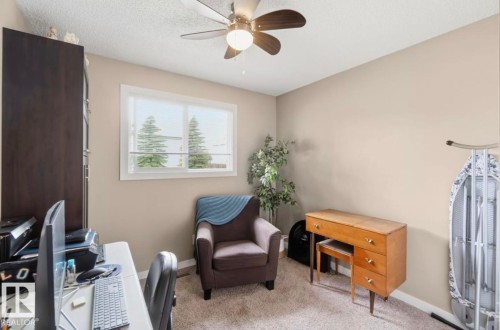 Neutral tone wall finish, carpeted flooring, and a ceiling fan with integrated lighting - 4007 45 Street, Stony Plain, AB 