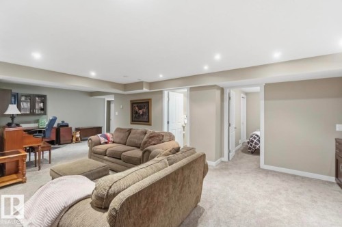 Expansive carpeted room with recessed lighting, light-toned walls, and white trim - 4007 45 Street, Stony Plain, AB 