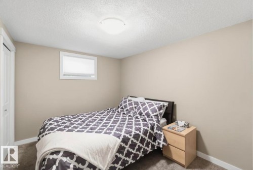 Neutral painted walls with white trim, a recessed window, and textured carpeting - 4007 45 Street, Stony Plain, AB 