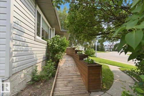 Accessible wood-finish ramp entrance featuring integrated planter boxes - 4007 45 Street, Stony Plain, AB 