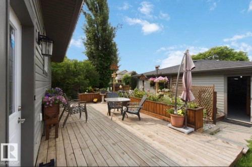 Expansive wood deck with built-in planters and fencing, offering outdoor living space - 4007 45 Street, Stony Plain, AB 
