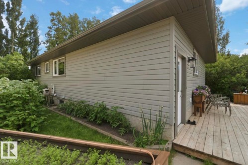 Exterior siding with multiple windows and a side entry door - 4007 45 Street, Stony Plain, AB 