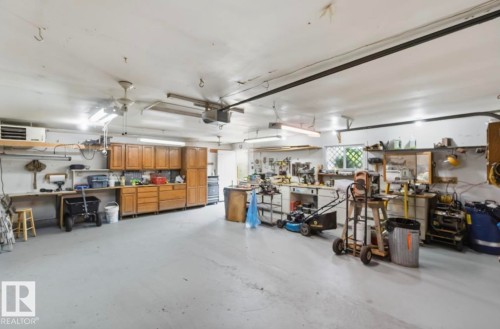 Spacious garage with light gray flooring and white walls - 4007 45 Street, Stony Plain, AB 