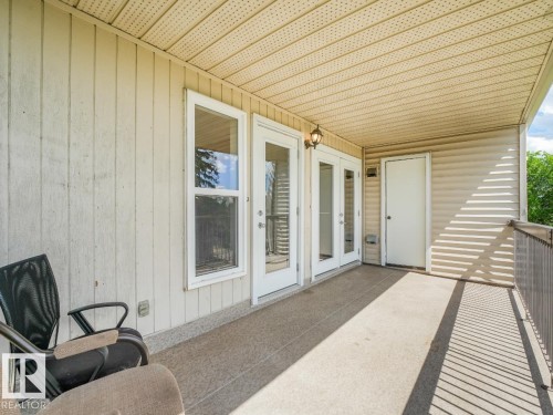 Covered balcony featuring textured concrete flooring - 301 10528 29 Avenue, Edmonton, AB 