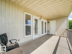 Covered balcony featuring textured concrete flooring - 
