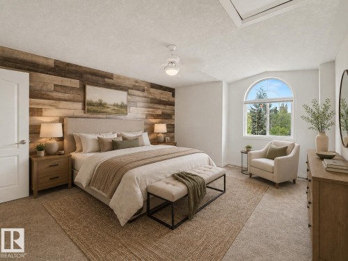 Spacious bedroom featuring an accent wall with varied wood paneling, an arched window, and vaulted ceilings - 1619 Welbourn Cove, Edmonton, AB 