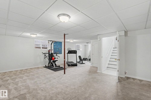 Finished lower level featuring recessed lighting, a drop ceiling, and carpeted flooring - 1619 Welbourn Cove, Edmonton, AB 