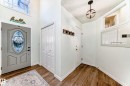 Entryway with wood-finish flooring and a decorative door featuring stained glass - 1619 Welbourn Cove, Edmonton, AB 