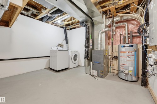 Utility space featuring a water heater, furnace, and laundry appliances - 126 2051 Towne Centre Boulevard, Edmonton, AB 