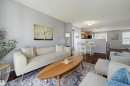 Open-concept living space featuring wood-finish flooring, light gray wall tones, and recessed lighting - 126 2051 Towne Centre Boulevard, Edmonton, AB 