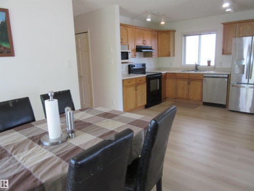 Kitchen with wood-finish flooring and track lighting - 64 Heatherglen Close, Spruce Grove, AB 