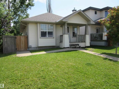 Exterior featuring light-colored siding, a covered front porch, and a fenced side yard - 64 Heatherglen Close, Spruce Grove, AB 