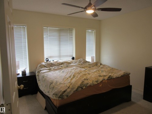 Room featuring broadloom carpeting and a ceiling fan with integrated lighting - 64 Heatherglen Close, Spruce Grove, AB 