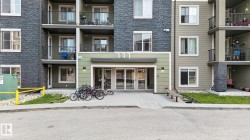 Contemporary multi-story building featuring stone veneer and horizontal siding - 