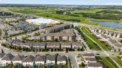 Urban residential development featuring a commercial center, multi-level apartment buildings, and single-family homes - 