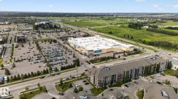 Aerial perspective showcasing a multi-story residential building with private balconies and surface parking - 