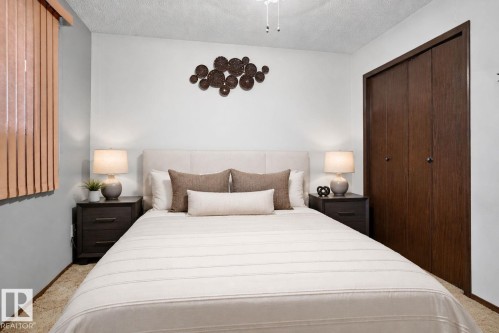 Bedroom featuring light gray walls, textured ceiling, a ceiling fan, and carpet flooring - 4712 131 Avenue Nw, Edmonton, AB 