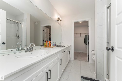 Double vanity with undermount sinks, chrome fixtures, and extensive countertop space - 102 Horton Way, Ardrossan, AB 