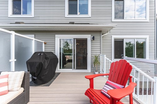 Spacious composite deck with white railing and privacy screen - 102 Horton Way, Ardrossan, AB 