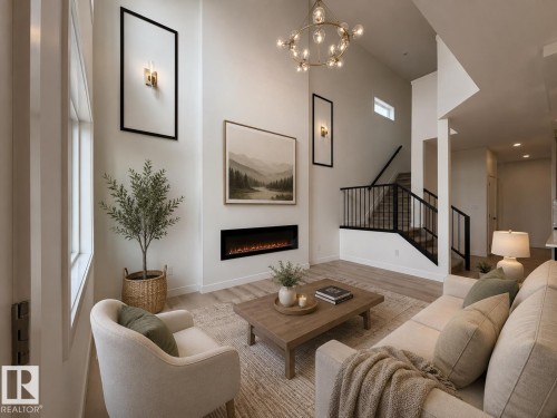 Living room with high ceilings, wood-finish flooring, an integrated electric fireplace, and a contemporary chandelier - 115 Pierwyck Loop, Spruce Grove, AB 