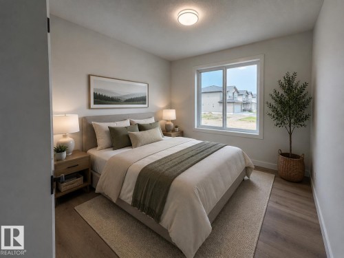 Light-filled room featuring wood-finish flooring, a contemporary ceiling light fixture, and a large window with white trim - 115 Pierwyck Loop, Spruce Grove, AB 