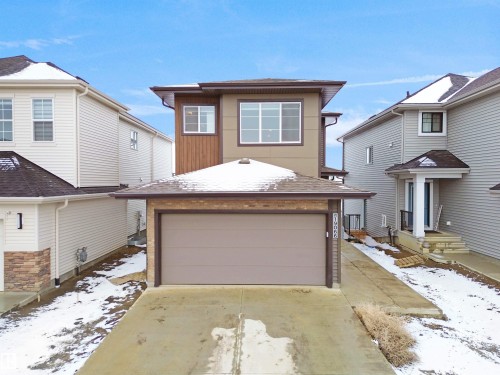 Contemporary exterior featuring a two-car garage, varied siding textures, and a prominent front entrance - 19066 20A Avenue, Edmonton, AB 