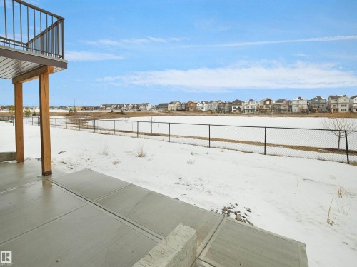 Rear patio with concrete flooring, covered area, and structural support beams - 19066 20A Avenue, Edmonton, AB 