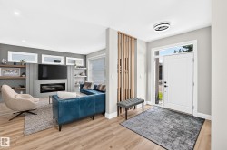 Entryway with wood-finish flooring and a contemporary front door with sidelight - 