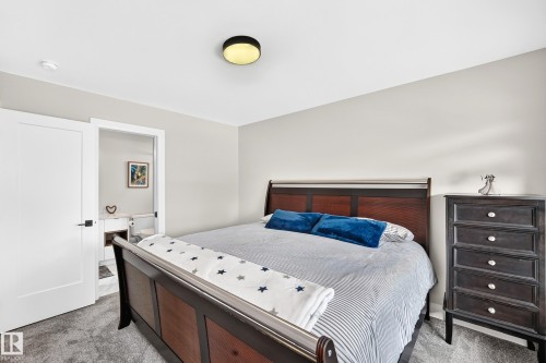 Spacious room featuring light gray wall paint and gray carpet flooring - 12631 52 Avenue, Edmonton, AB 