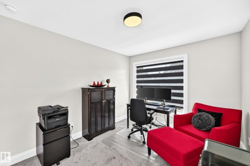 Bright room featuring a window with horizontal blinds, light gray wall paint, and overhead flush-mount lighting - 12631 52 Avenue, Edmonton, AB 