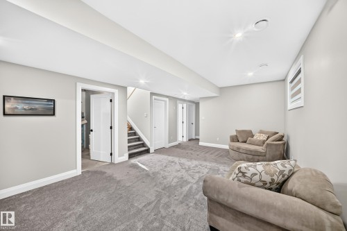 Spacious room with gray carpeting, recessed lighting, white walls, white trim, and a window with blinds - 12631 52 Avenue, Edmonton, AB 
