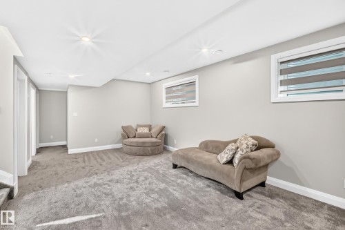 Spacious room featuring light gray wall paint, recessed lighting, white baseboards, and two windows with horizontal blinds - 12631 52 Avenue, Edmonton, AB 
